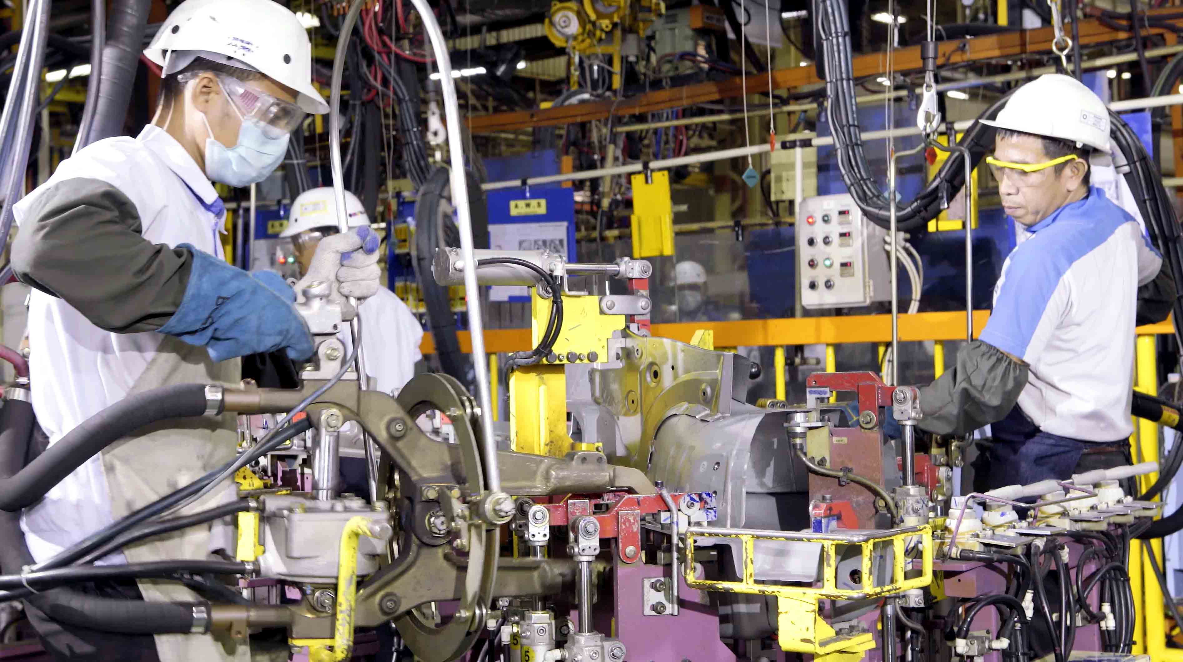 Manufacturing team working safely around production machinery